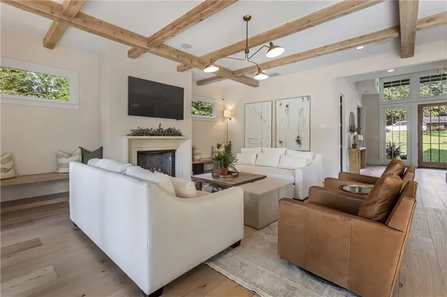 a dining room with furniture a chandelier and wooden floor
