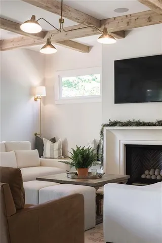 a dining room with furniture a chandelier and windows
