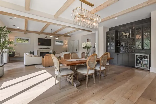 a kitchen with a table chairs refrigerator and microwave