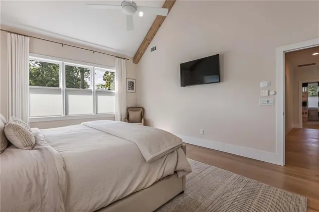 a spacious bedroom with a bed and a couch