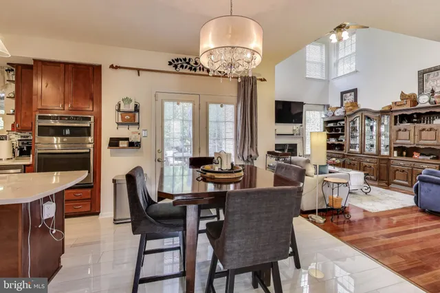 a living room with fireplace furniture and a chandelier