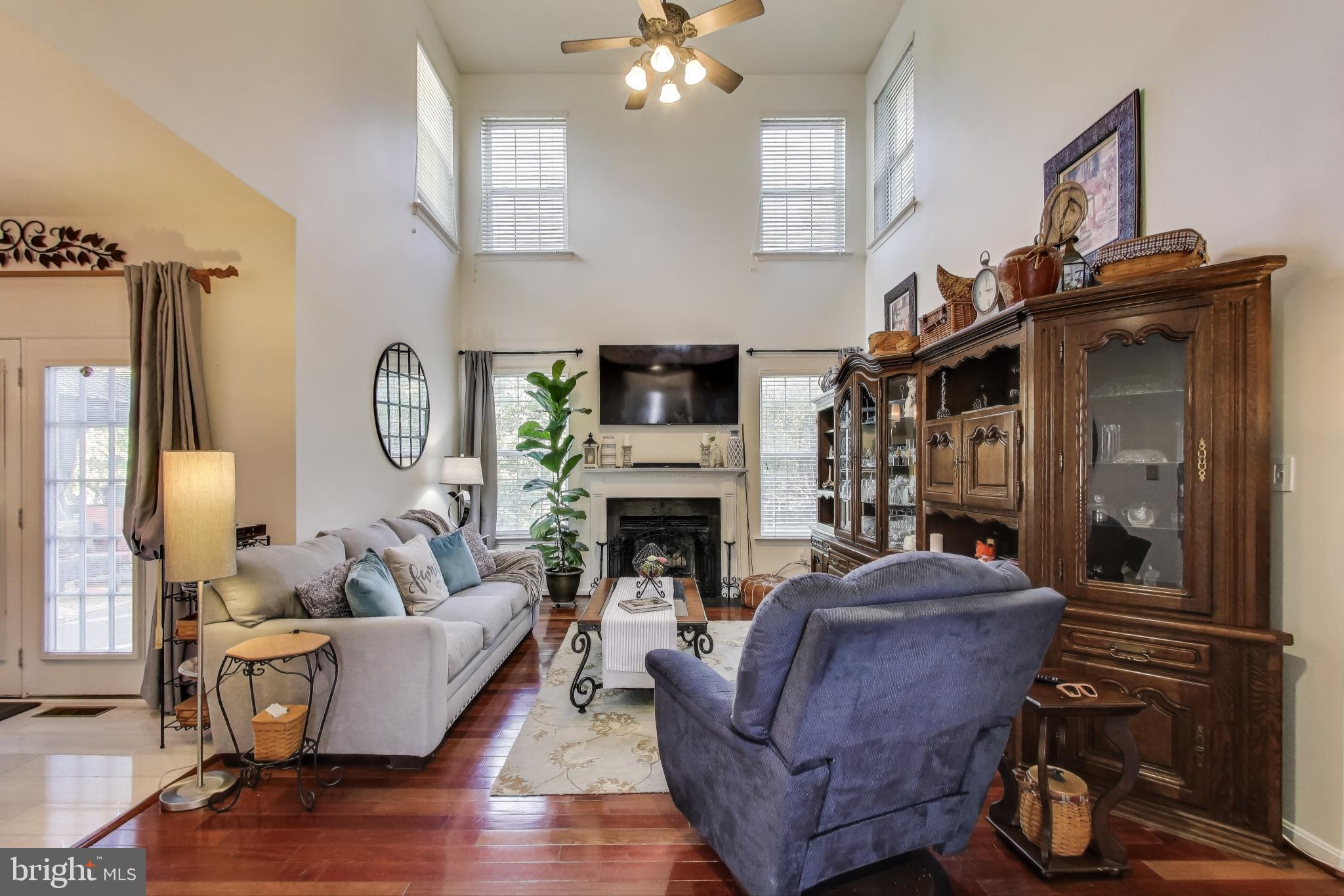 2323 Springdale Lane Waldorf, MD 20603 - Photo 14 of 51 a living room with furniture a fireplace and a chandelier
