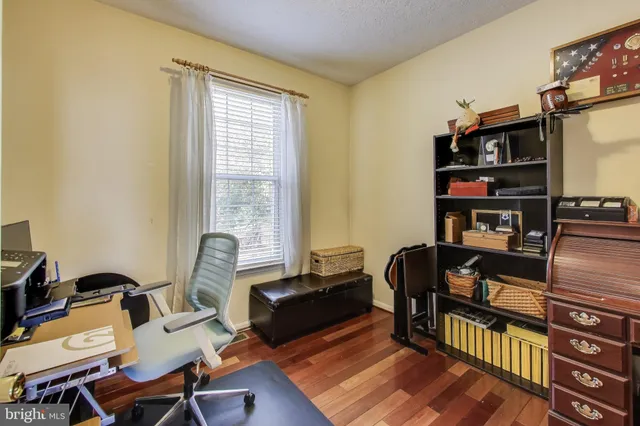 a living room with furniture a rug and a window