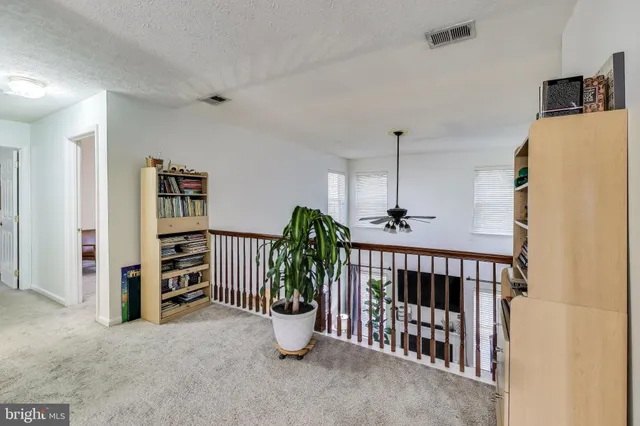 a view of a hallway with seating area