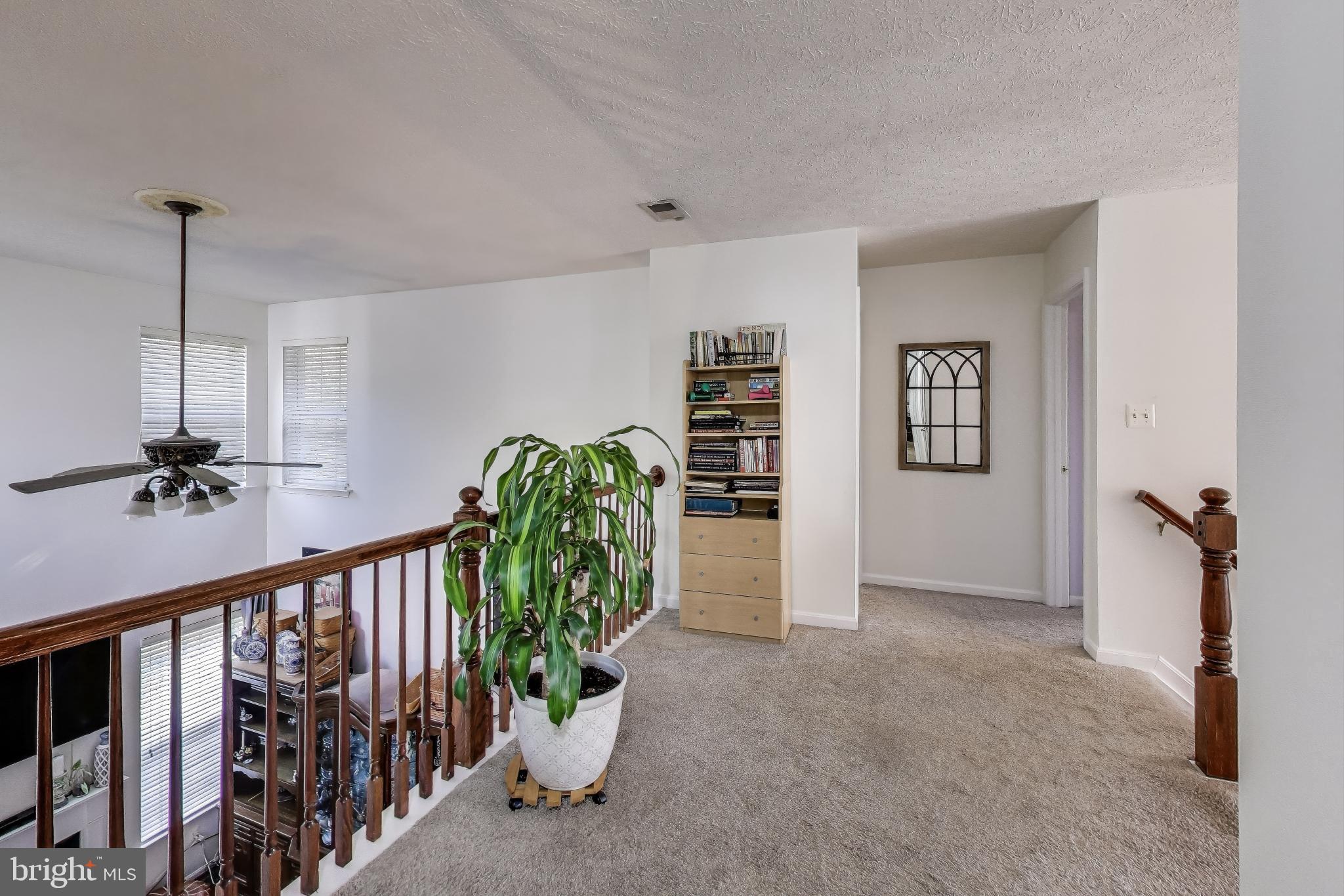 2323 Springdale Lane Waldorf, MD 20603 - Photo 22 of 51 a view of a hallway with wooden floor and stairs