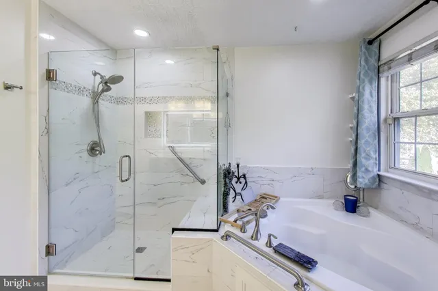 a bathroom with a bathtub and a shower