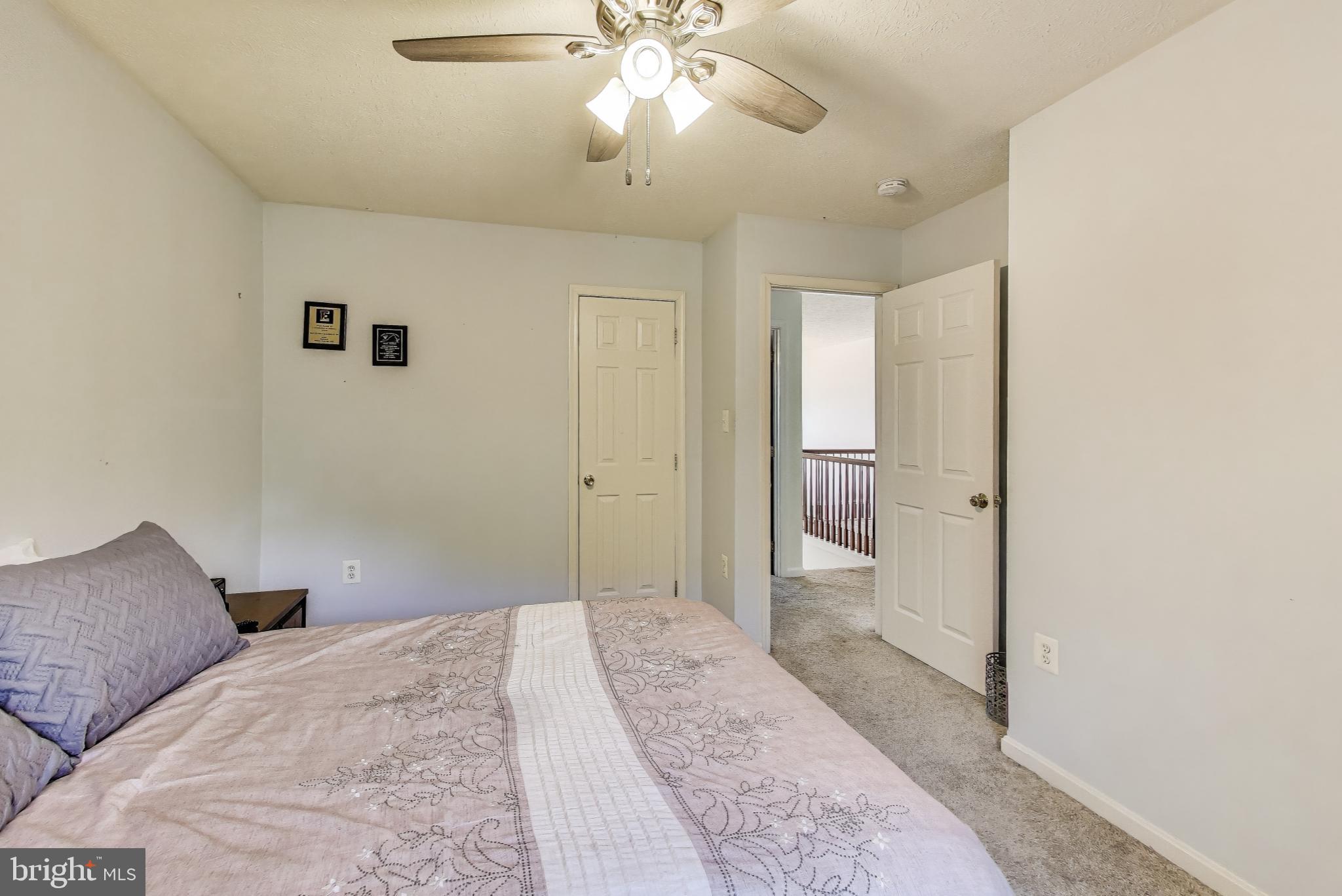 2323 Springdale Lane Waldorf, MD 20603 - Photo 32 of 51 a bedroom with a large bed and a chandelier fan