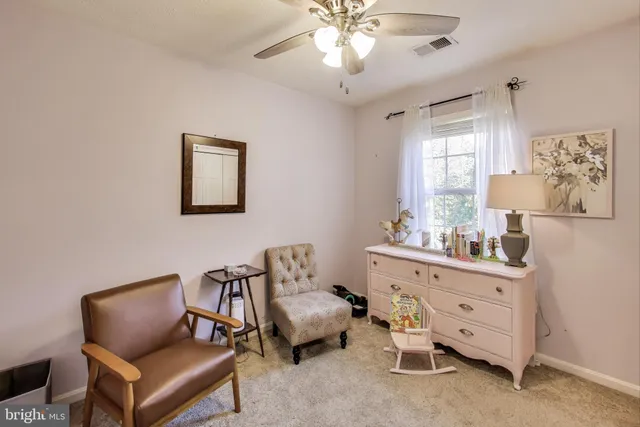 a hallway with furniture and a bookshelf