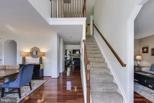 a view of entryway and hall with wooden floor