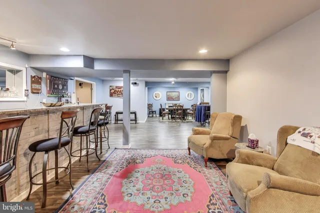 a dining room with furniture and wooden floor