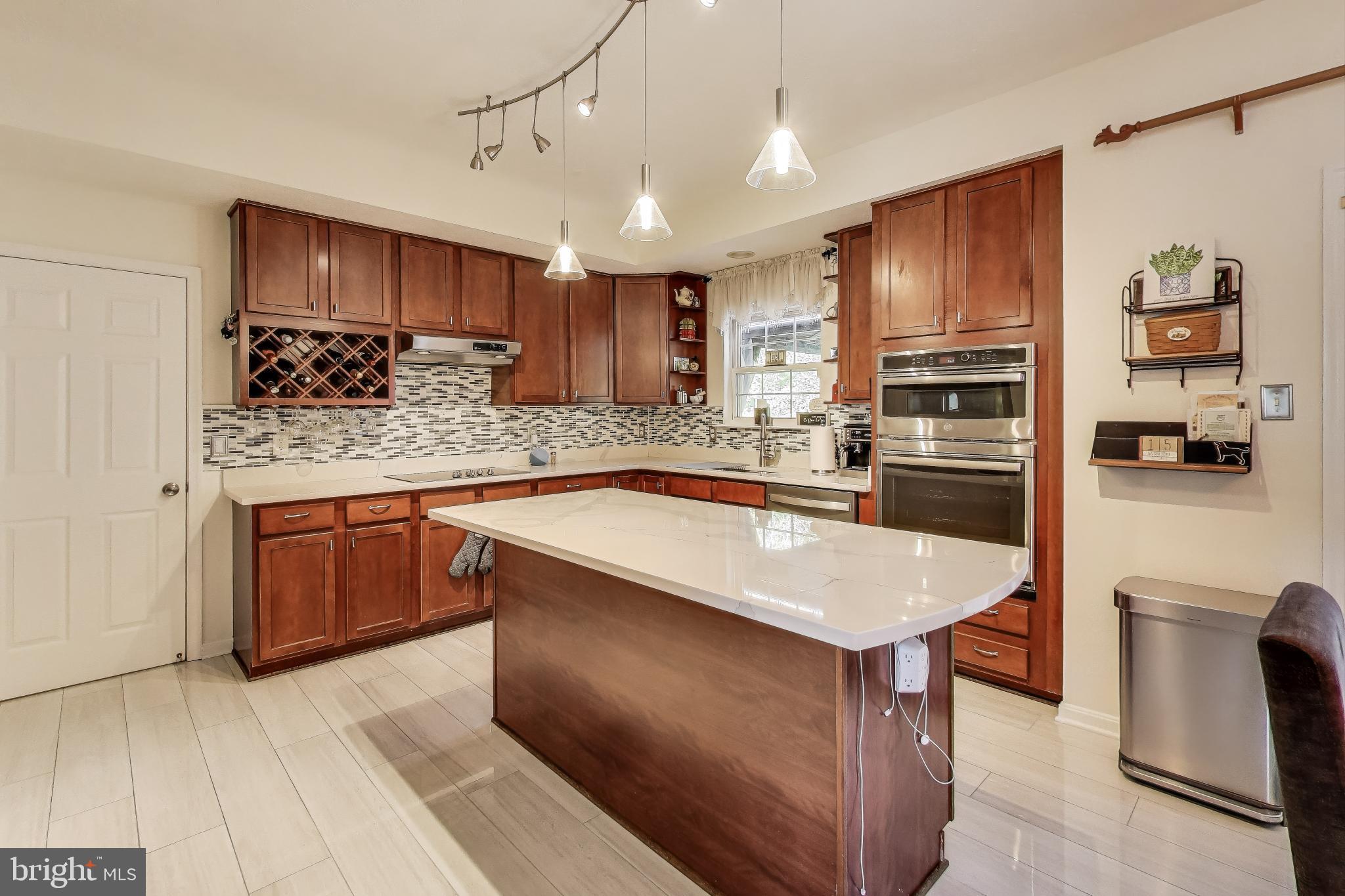 2323 Springdale Lane Waldorf, MD 20603 - Photo 9 of 51 a kitchen with stainless steel appliances granite countertop a sink stove and refrigerator