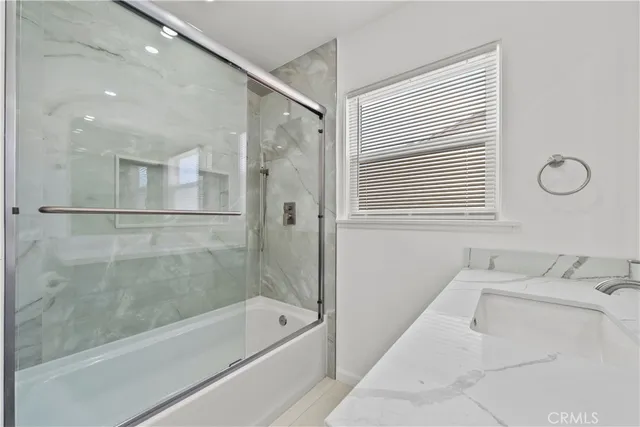 a large kitchen with kitchen island a sink stainless steel appliances and cabinets