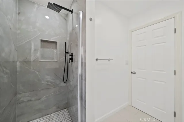 a kitchen with white cabinets appliances a sink and a window