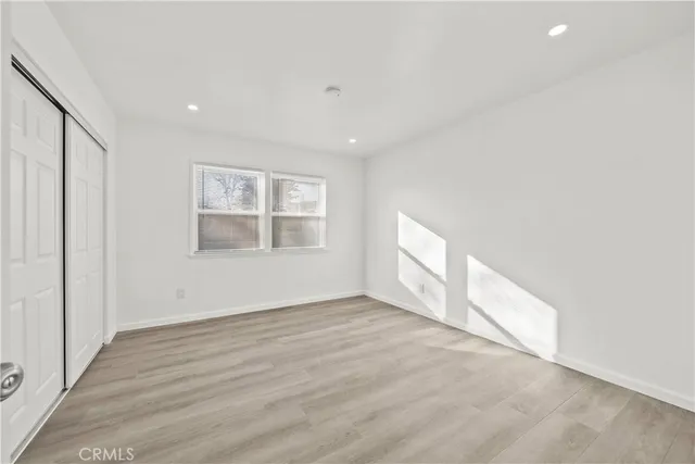 a bathroom with a granite countertop sink a mirror and a bathtub