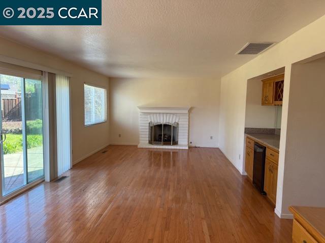 Dana Hills Clayton, CA 94517 - Photo 6 of 15 a view of an empty room with wooden floor fireplace and a window