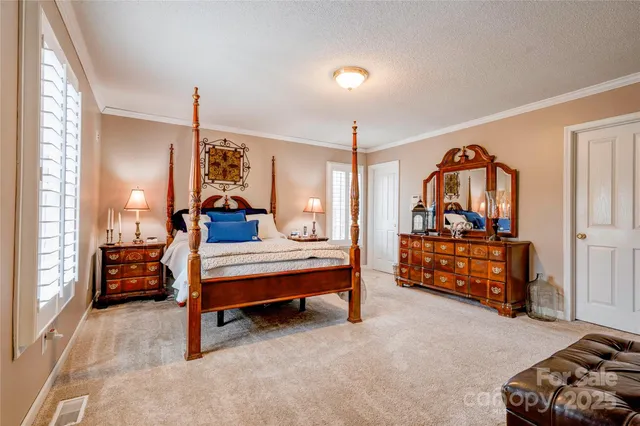 a bedroom with furniture and a dresser