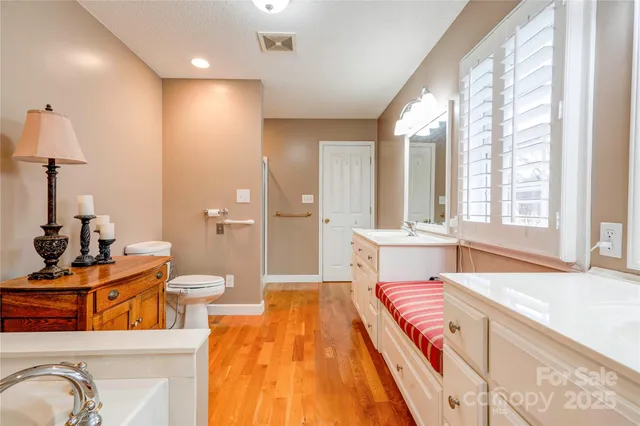 a spacious bedroom with a bed and a window