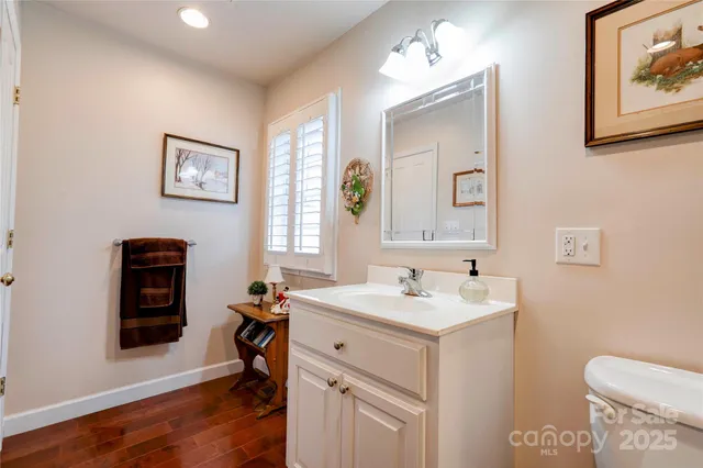 a bathroom with a toilet a sink and a mirror