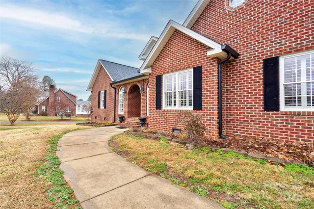 an empty room with fireplace and windows