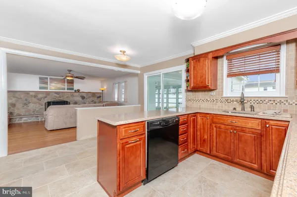 a large kitchen with stainless steel appliances granite countertop a sink and cabinets