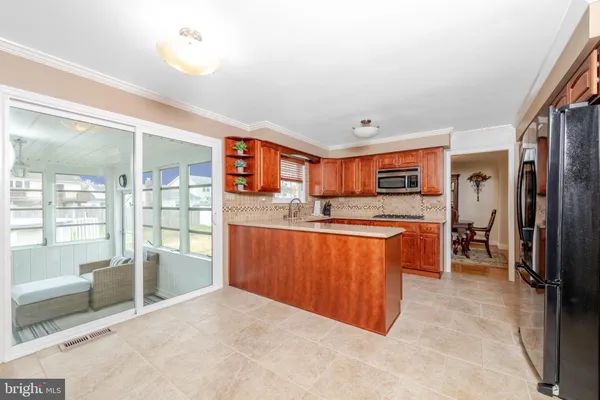 a kitchen with stainless steel appliances granite countertop a refrigerator and a sink