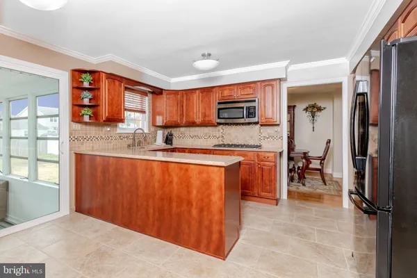 a kitchen with stainless steel appliances granite countertop a refrigerator stove and sink