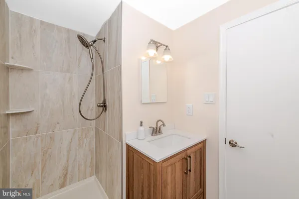 a bathroom with a sink vanity and a mirror