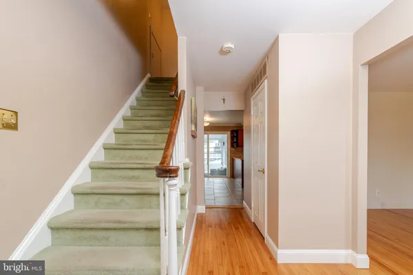 a view of entryway and hall with wooden floor