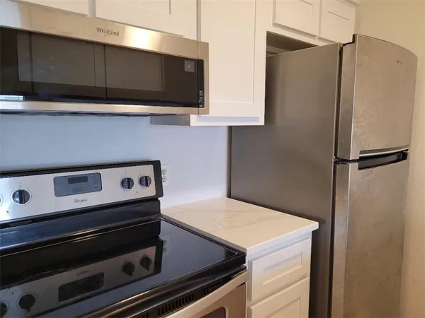 a kitchen with a stove and a microwave