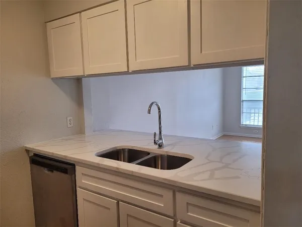 a kitchen with a sink and cabinets