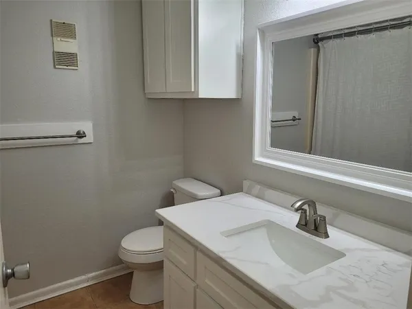 a bathroom with a sink a toilet and vanity