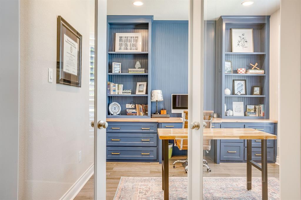 5709 Pope Creek Road Fort Worth, TX 76126 - Photo 6 of 39 Located at the front of the home, double glass doors open to a stunning office space featuring built-in blue cabinetry, integrated shelving, beadboard accents, and light wood-finish countertops.