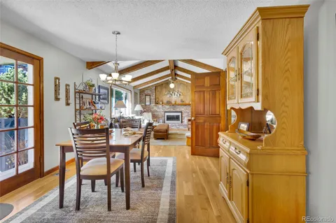 a view of a dining room with furniture and a chandelier