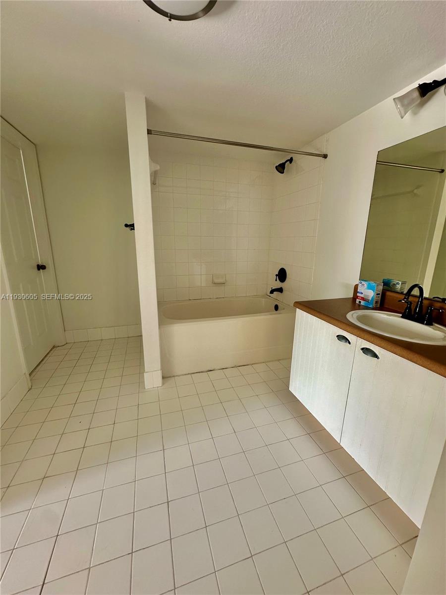 4190 San Marino Boulevard, Unit 303 West Palm Beach, FL 33409 - Photo 11 of 19 a bathroom with a bathtub and a shower