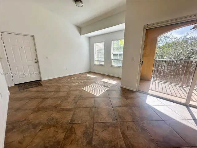 a view of an empty room with glass door