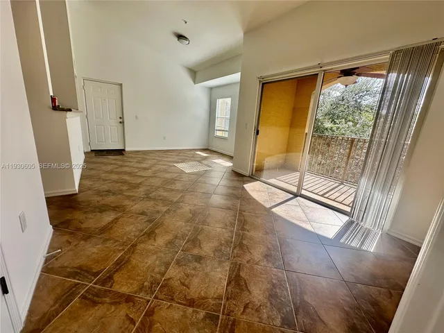 a view of empty room with wooden floor and front door