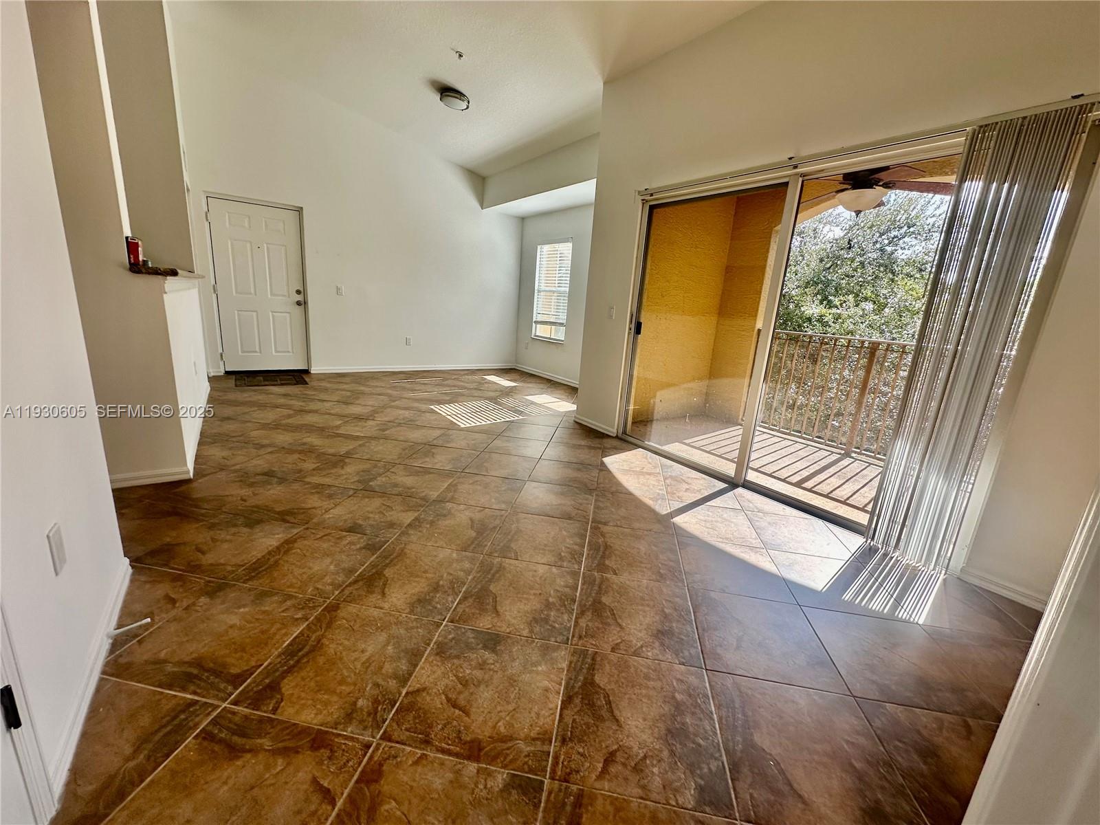 4190 San Marino Boulevard, Unit 303 West Palm Beach, FL 33409 - Photo 6 of 19 a view of empty room with wooden floor and front door