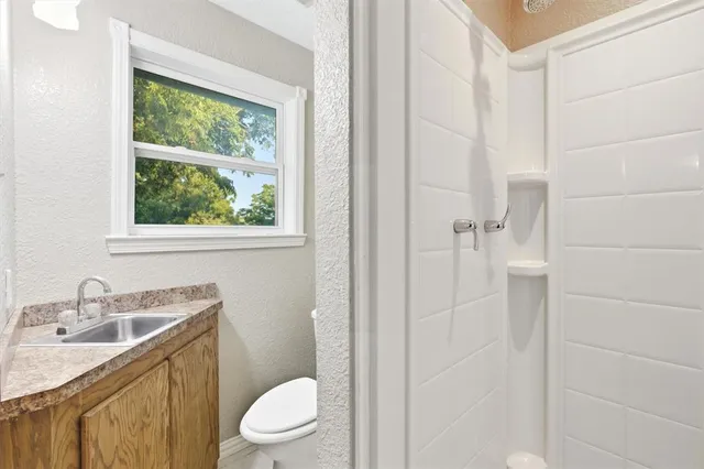 a bathroom with a sink toilet and shower