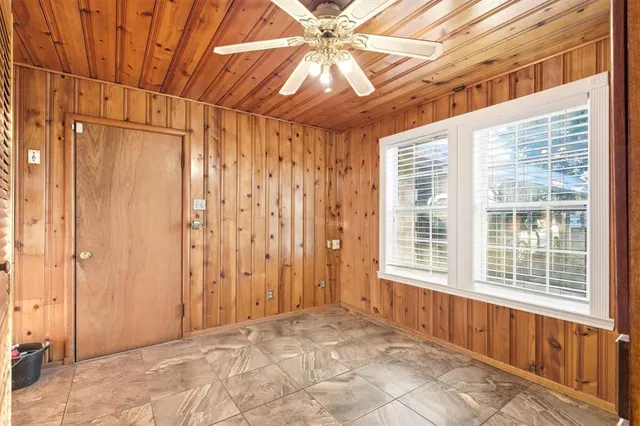 a view of a room with a window and a ceiling fan