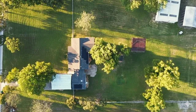 an aerial view of ocean with residential house with outdoor space