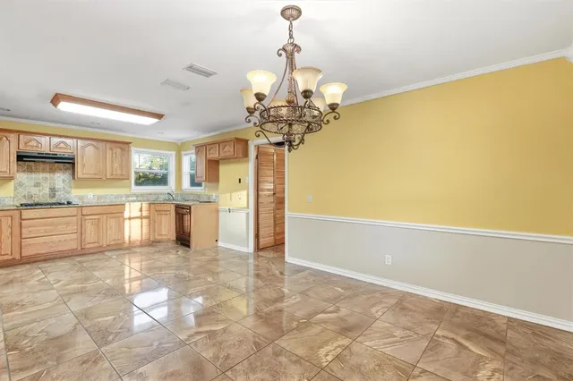 a view of a kitchen with a sink stainless steel appliances and cabinets