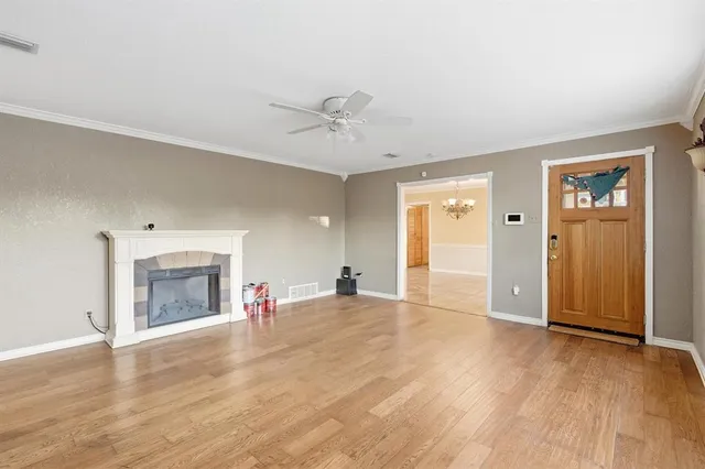 a view of empty room with wooden floor and fireplace