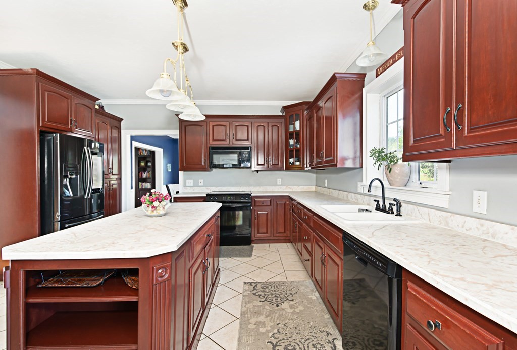 137 Osgood Road Charlton, MA 01507 - Photo 16 of 41 a kitchen with stainless steel appliances granite countertop a kitchen island a cabinets a sink and a refrigerator