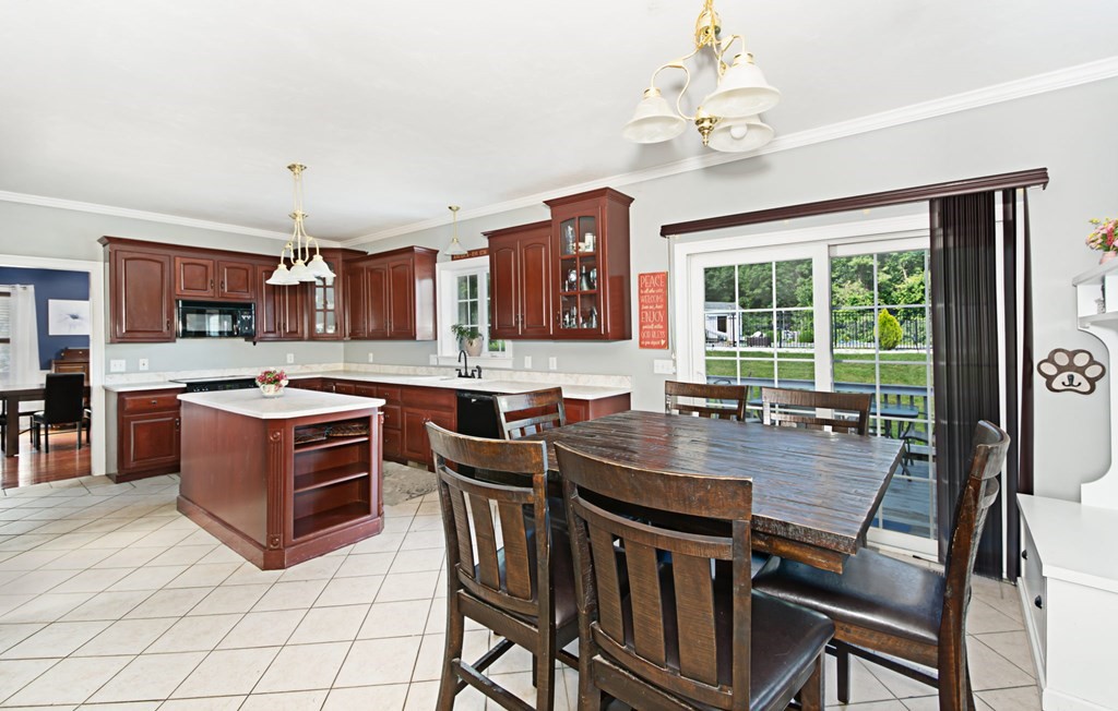 137 Osgood Road Charlton, MA 01507 - Photo 19 of 41 a kitchen with stainless steel appliances granite countertop a stove a sink a microwave dining table and chairs