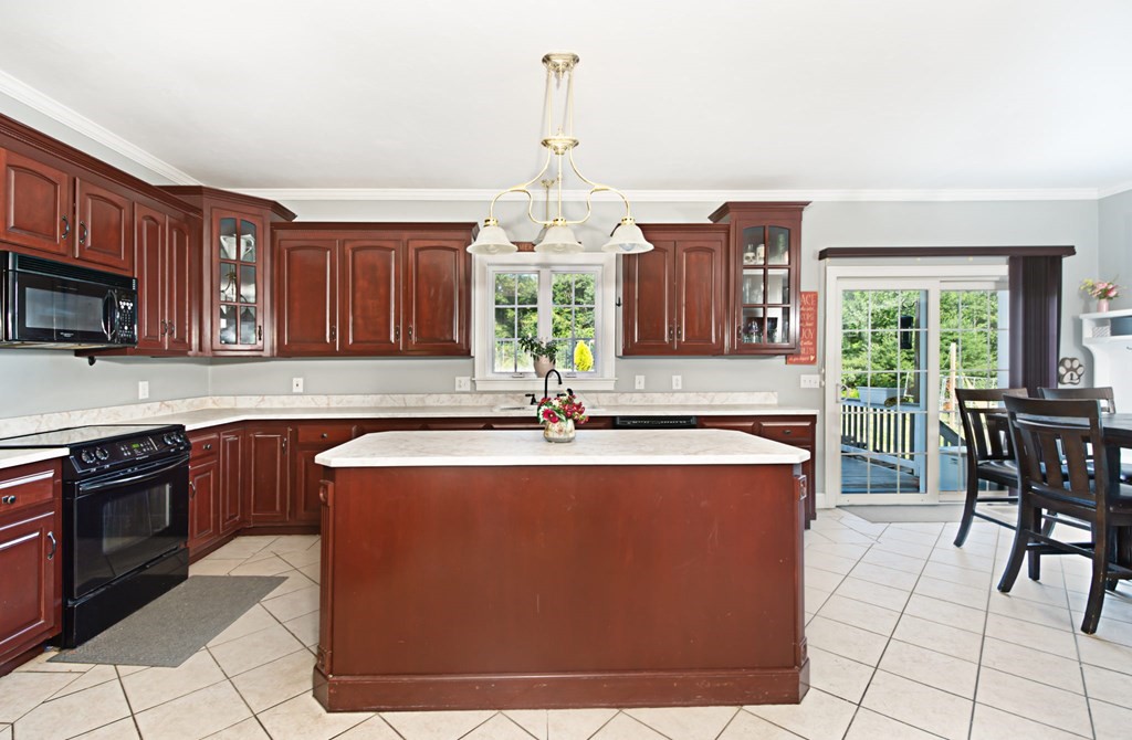 137 Osgood Road Charlton, MA 01507 - Photo 21 of 41 a large kitchen with kitchen island granite countertop a stove a sink dishwasher and a microwave