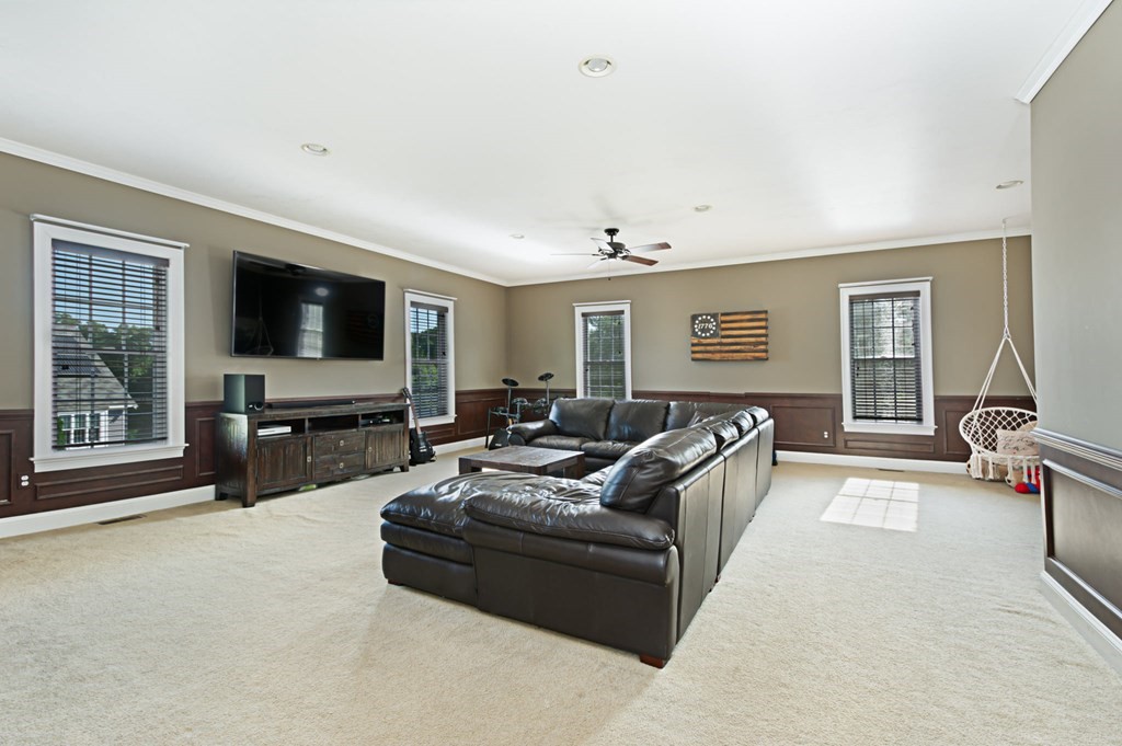 137 Osgood Road Charlton, MA 01507 - Photo 25 of 41 a living room with furniture and a flat screen tv