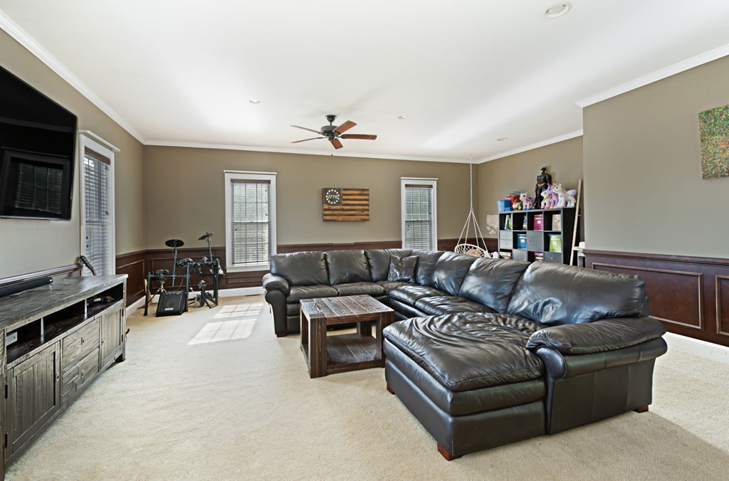 137 Osgood Road Charlton, MA 01507 - Photo 26 of 41 a living room with furniture and a flat screen tv