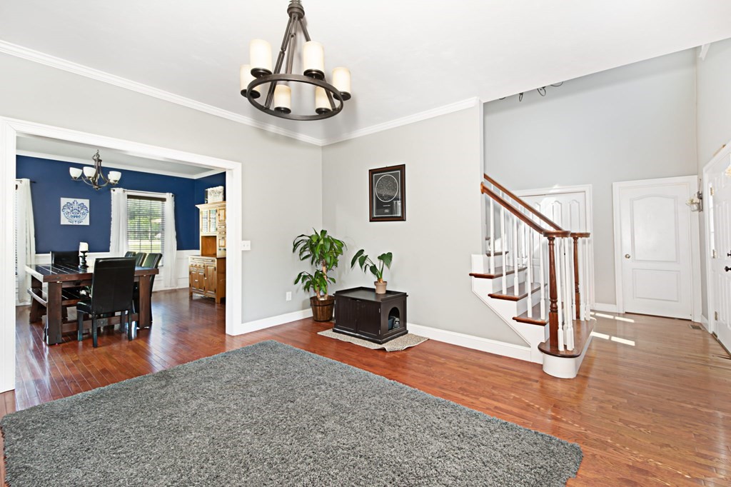 137 Osgood Road Charlton, MA 01507 - Photo 30 of 41 a living room with furniture and a chandelier