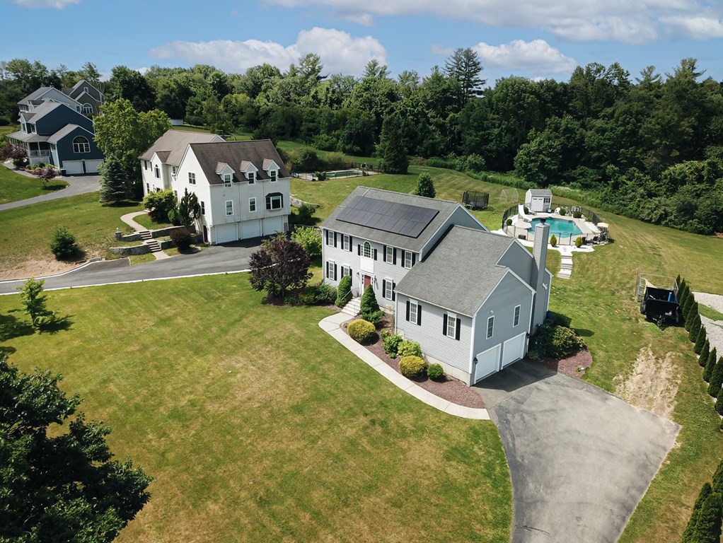 137 Osgood Road Charlton, MA 01507 - Photo 3 of 41 an aerial view of a house with swimming pool and large trees