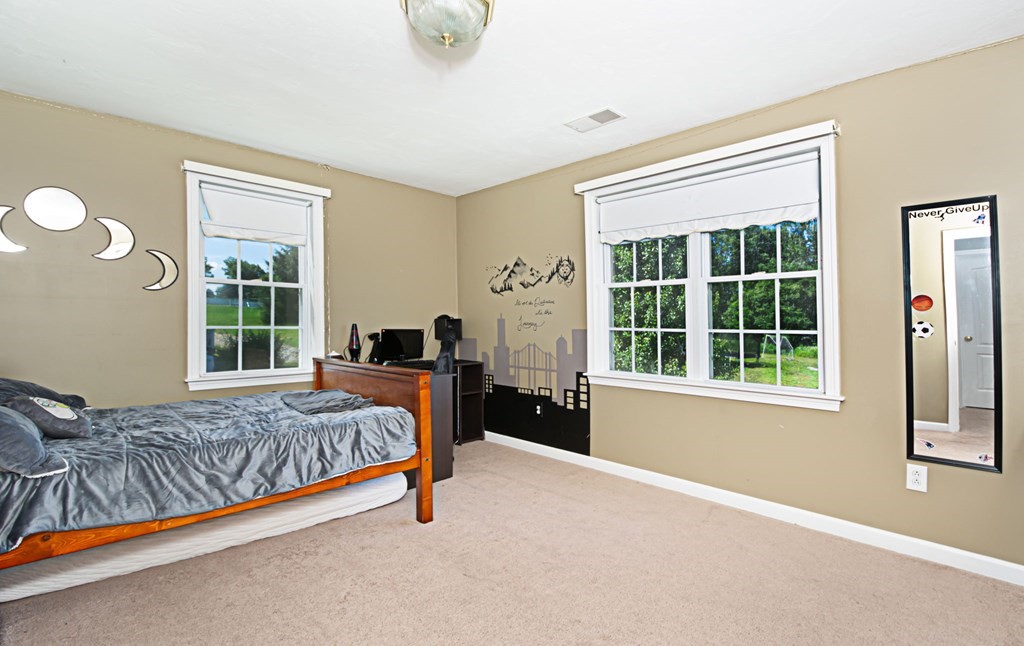 137 Osgood Road Charlton, MA 01507 - Photo 32 of 41 a bedroom with a bed lamp and a large window
